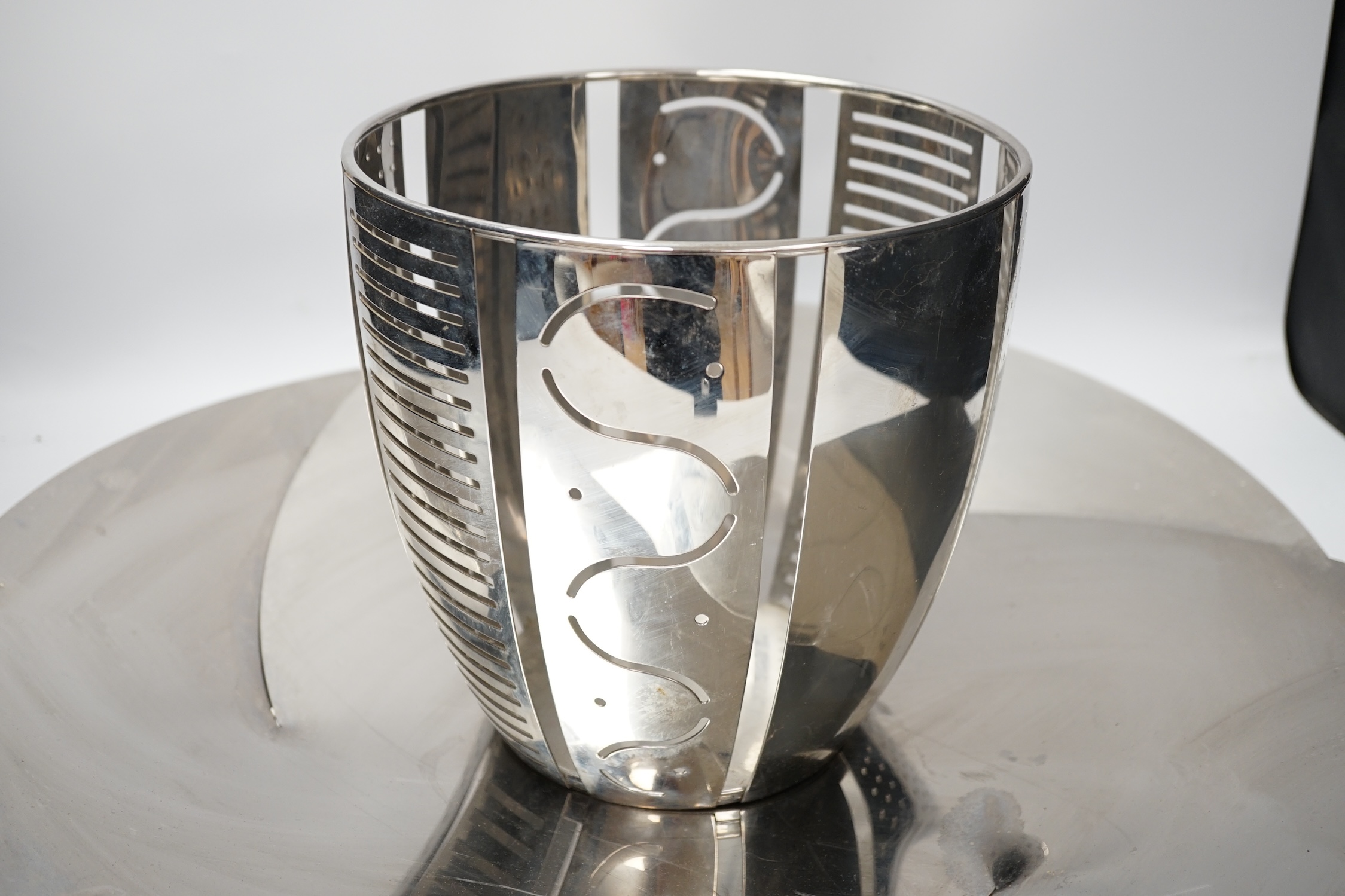 A large Alessi Resonance Albi Alice Collection fruit bowl and an Alessi Helmut magazine holder, fruit bowl 56.5cm diameter. Condition - bowl poor as badly scratched, magazine holder good